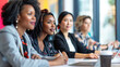 © ksu_ok - Diverse group of female executives engaged in a business meeting, with focus on a confident African American woman