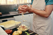 © ThaaJamSession/peopleimages.com - Kitchen, bowl and hands of person with cooking for dinner, nutrition and healthy diet at home. Counter, ingredients and cuisine with mixing in container for meal prep, vegetables and pastry dish