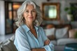© Konstiantyn Zap - Serene sophistication: An elegant woman in a light blue blouse exudes poise and sophistication with her graceful gray hair.