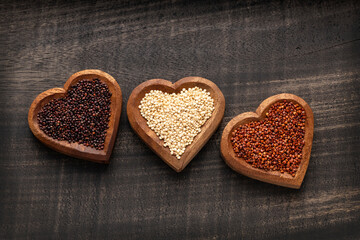 Poster - Chenopodium quinoa - White, red and black quinoa seeds in three heart-shaped bowls