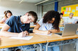 © Xavier Lorenzo - Diverse young students doing an exam at high school classroom. Education lifestyle and back to school concept.