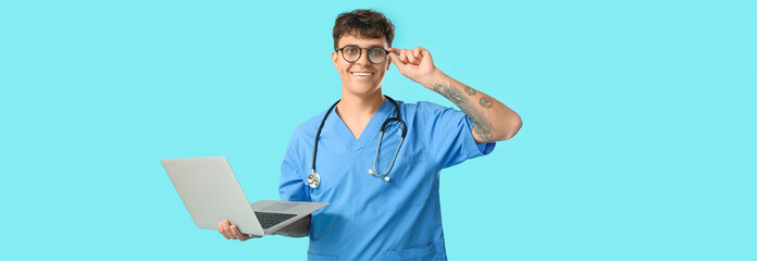 Sticker - Male medical student with modern laptop on blue background