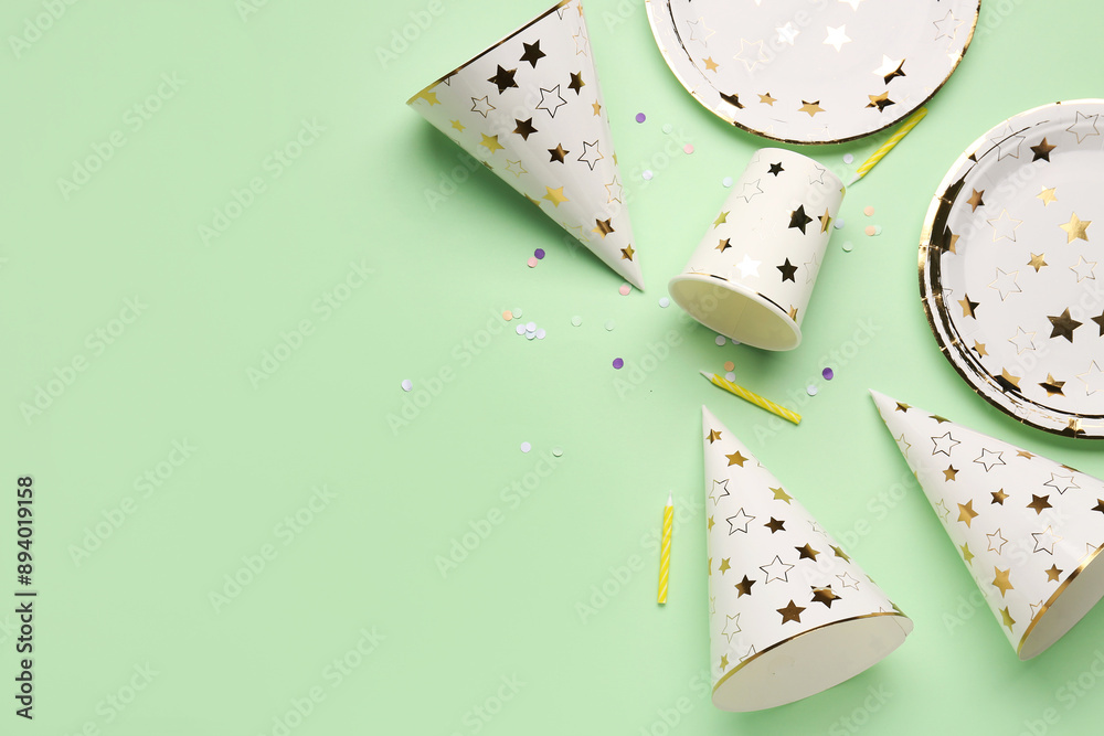 Set of party decor with hats on color background