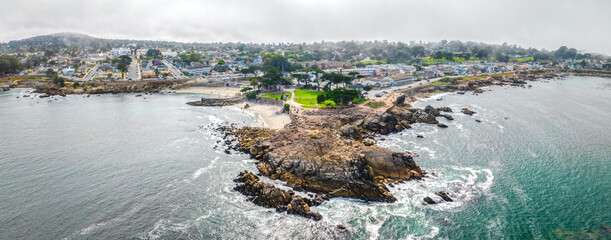 Wall Mural - Drone view of Pacific Grove, California with ocean and city