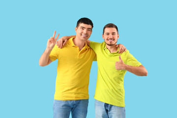 Sticker - Handsome young brothers on blue background