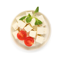 Canvas Print - Plate with tasty cut feta cheese, tomatoes and salad leaves on white background