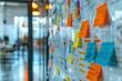© Phichaphat - Dynamic workspace featuring a colorful brainstorming wall with sticky notes and diagrams for collaborative idea generation.