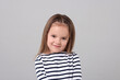 © New Africa - Portrait of cute little girl on grey background