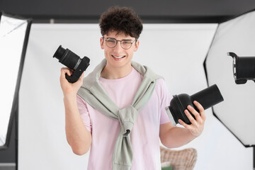 Wall Mural - Professional happy male photographer with modern camera in studio