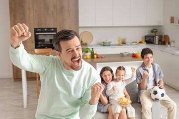 Sticker - Cheerful father and his family watching soccer game at home