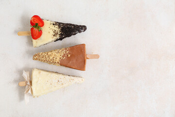 Wall Mural - Tasty cheesecake pops on light background with space for text