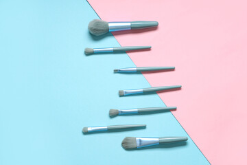 Wall Mural - Different stylish makeup brushes on color background