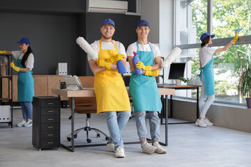 Poster - Male janitor with cleaning supplies in office