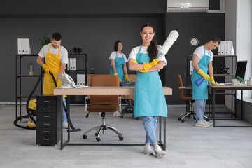 Canvas Print - Female Asian janitor with pp-duster in office