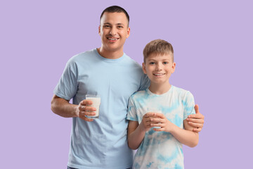 Poster - Little boy and his father with glasses of milk on lilac background