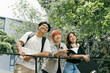 © Parichat - Group of Happy Students Outdoors Holding Books and Smiling in a Green Campus Environment