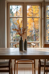 Interior of modern dining room with wooden table, chairs, vases and window with autumnal foliage