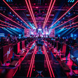 © Hikmet - A eSports championship is taking place in an impressive arena adorned with neon lights. The victor's trophy stands prominently on stage, surrounded by rows of computers for the competing teams.