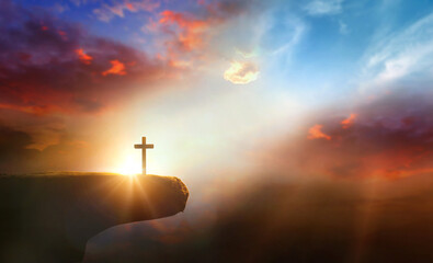 Wall Mural - cross on the cliff and sunset sky background.