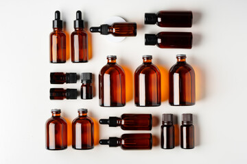 Wall Mural - Mock up of amber glass bottles on white background flat lay