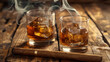 © Curioso.Photography - Two glasses of whiskey with ice and cigars on a rustic wooden table.