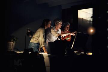 Canvas Print - Business team, computer and research at night in office for company project, diversity and late deadline. Digital agency, working and strategy in workplace as women with burnout for collaboration