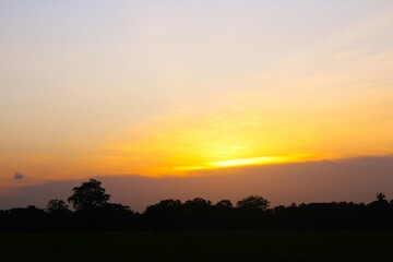 Wall Mural - Sunset Sky Orange Cloud Sunrise Background Evening Golden Hour Blue Dawn Twilight Summer blur Nature Night Horizon Sun Clear Beautiful Clean Cloudy Light Dramatic Bright Calm Yellow Soft Warm Abstract