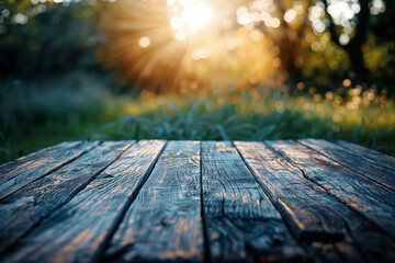 Poster - Empty wooden table top showing blurred green grass and trees with sun shining through, perfect for product display montage