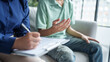 © Charlie's - sad male sitting on sofa Patient discussing mental health issues with psychologist. depressed asian man mental health treatment