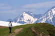 © dvulikaia - Man with backpack walks along  hiking trail in mountainous area. Hiking concept.