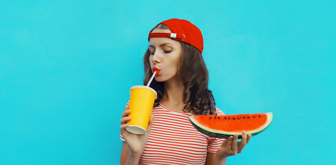 Summer portrait of young woman drinking juice with juicy slice watermelon fruit on blue background