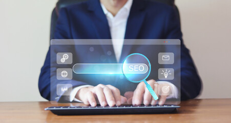 Poster - SEO concept. A businessman use computer and presses the button with an SEO icon for optimizing your website to rank in search engines or SEO, Monitoring and analyzing data.	