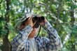 © Sophon_Nawit - Asian children using binoculars to do the birdwatching in tropical forest during summer camp, idea for learning creatures, wildlife animals and insects outside the classroom.