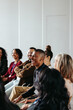 © Jacob Lund - Businessman laughing during a seminar with diverse group of people