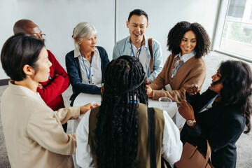 Wall Mural - cross-generational networking: diverse business people socializing in a modern office