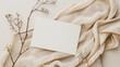 © mahamad - Blank Paper Sheet Card with Floral Branch: Featuring a dry floral branch and cloth on a neutral beige background, offering a minimal aesthetic template for business branding. Flat lay, top view.