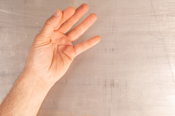 Poster - A hand is extended outward against a scratched surface