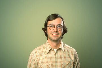 Wall Mural - Portrait of a young man in glasses and plaid shirt against a green background, showcasing a clean and approachable aesthetic, suitable for business or personal branding purposes.