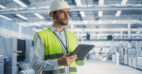 Aufkleber - Portrait Of Caucasian Male Engineer Standing In Factory Hall, Using Tablet Computer at a Machinery Manufacturing Facility. Specialist Using Online Software to Program Equipment on Production Line.