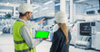 © Gorodenkoff - Caucasian Male Engineer Using Tablet Computer With Green Screen Chromakey on Display And Talking To Female Supervisor At Autonomous Assembly Line At Electronics Factory. Colleagues Discussing Projects