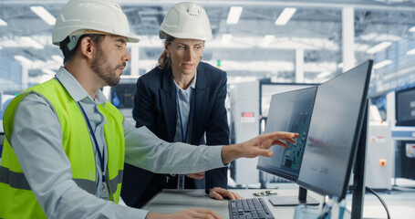 Fototapete - Electronics Research and Development Facility: Caucasian Female Manager Consults Male Engineer. Professionals Wear Hardhats And Design Microchips And Semiconductors On Computer At Modern Factory.