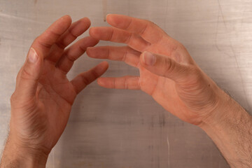 Poster - Two hands reach out as if to grasp something unseen