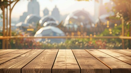 Poster - A wooden tabletop sits in front of a blurred background of a city cityscape with foliage and sunlight.