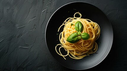 Wall Mural - Spaghetti with Basil on a Black Plate