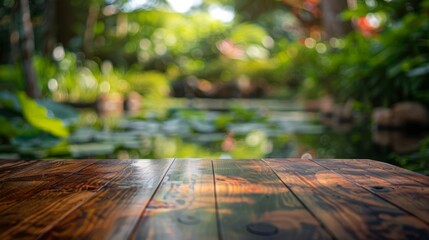Aufkleber - A wooden tabletop sits in the foreground of a lush garden, with a blurred pond and green foliage in the background.
