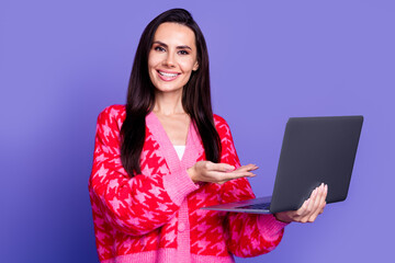 Wall Mural - Photo of cheerful pretty lady dressed pink cardigan showing arm modern device isolated violet color background