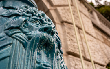 Vienna, Austria, August 21, 2022. Inside the Stadtpark, a large municipal park in the city center, the pedestrian path along the Wien river. Large blue vases with grotesque faces decorate it.