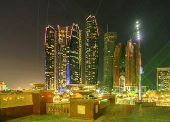 Abu Dhabi, UAE - December 3, 2014: Night view of high rise building with light and laser show
