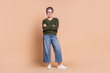 © deagreez - Photo of charming nice mature woman wear green stylish outfit crossed arms isolated on beige color background