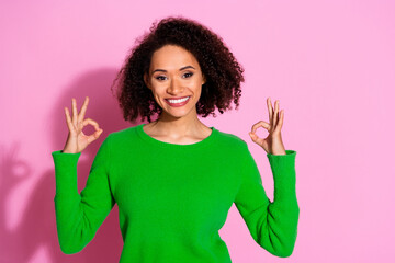 Sticker - Photo of positive satisfied cute woman wear green stylish clothes okey sign isolated on pink color background